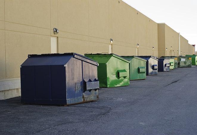 workers clearing construction waste into dumpsters in Florida, NY